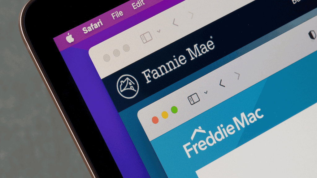 a photo of a laptop with two internet browser windows open - one with Fannie Mae's homepage and the other with Freddie Mac's