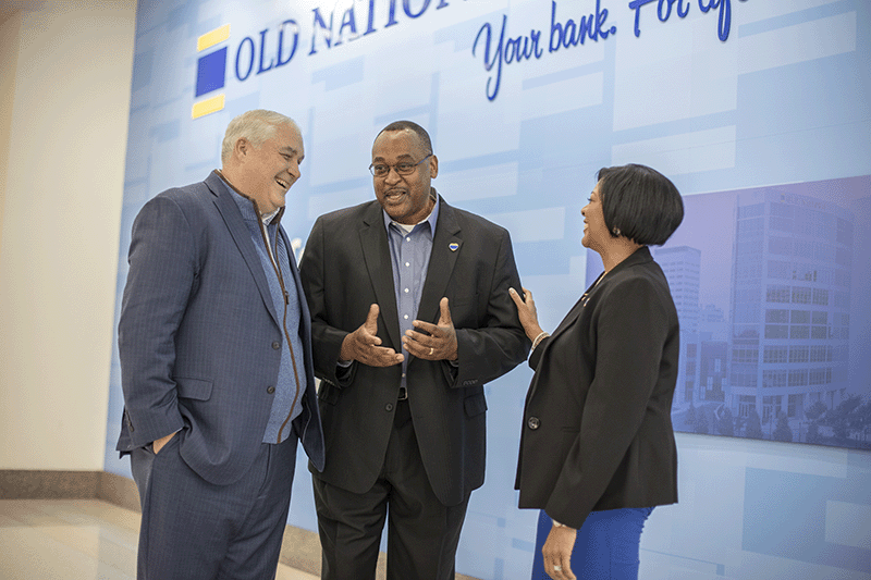 a photo of Jim Ryan speaking with colleagues from Old National