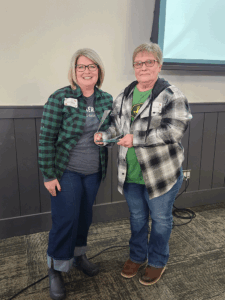 a photo of Kim Steele being presented the award by bank president & CEO Shane Pilarski