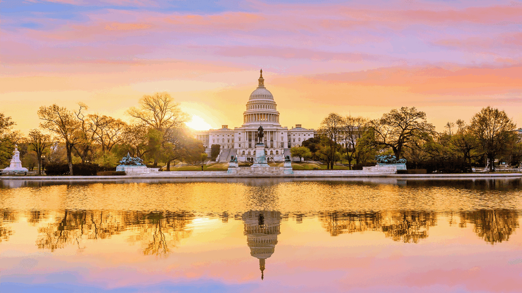 a photo showing the sun rise behind the U.S. Capitol building