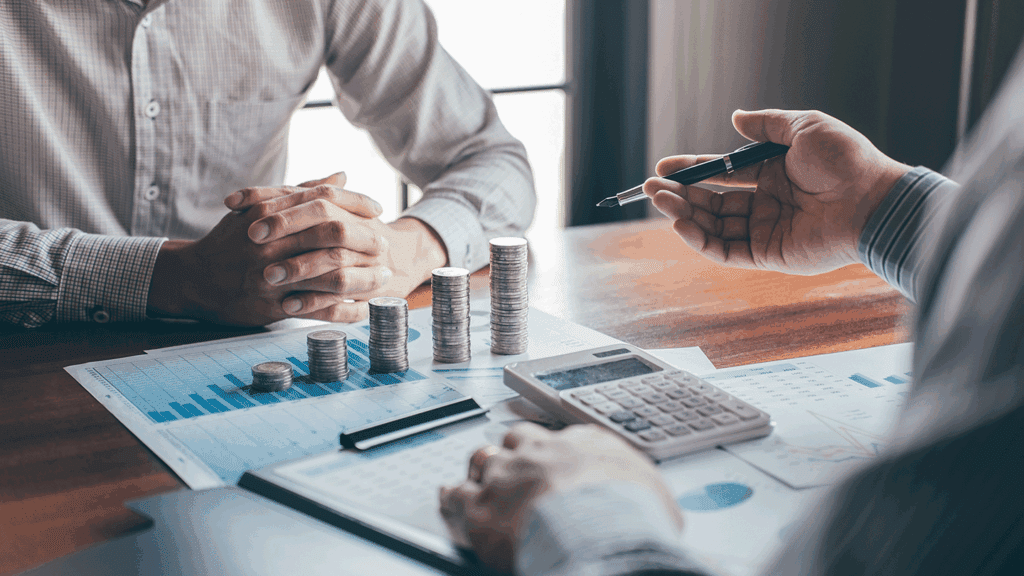 a photo showing two men in a business meeting discussing finances