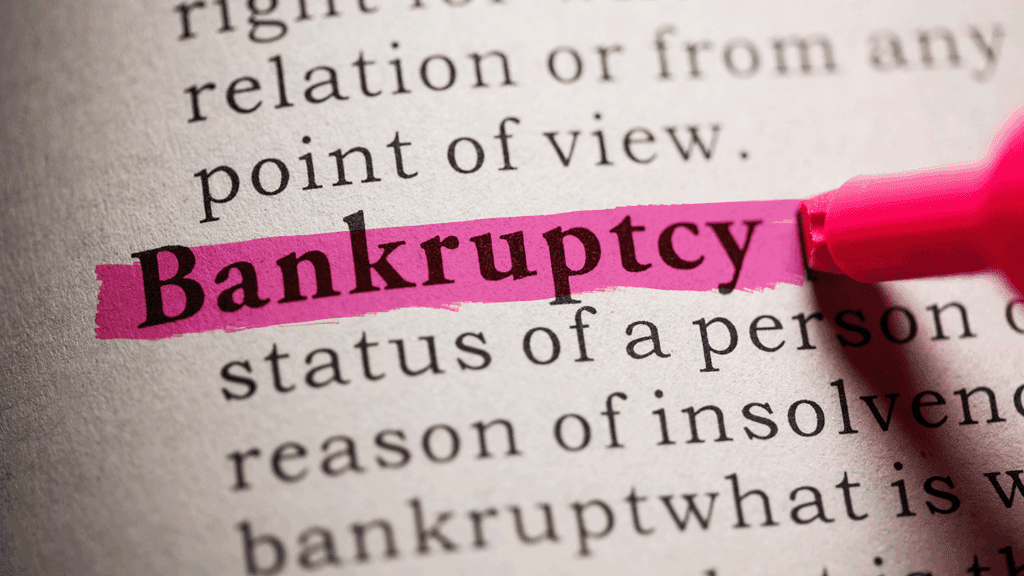 a photo showing a hand highlighting the word Bankruptcy in a dictionary