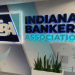 a photo showing the IBA logo as a lit sign on a wall inside the IBA office
