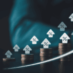 Stacks of coins increasing in height with percent arrows and a rising white line, signaling financial growth or rising rates.