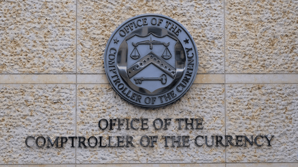 a photo of the office's seal on an exterior wall at the Office of the Comptroller of the Currency in Washington, D.C.