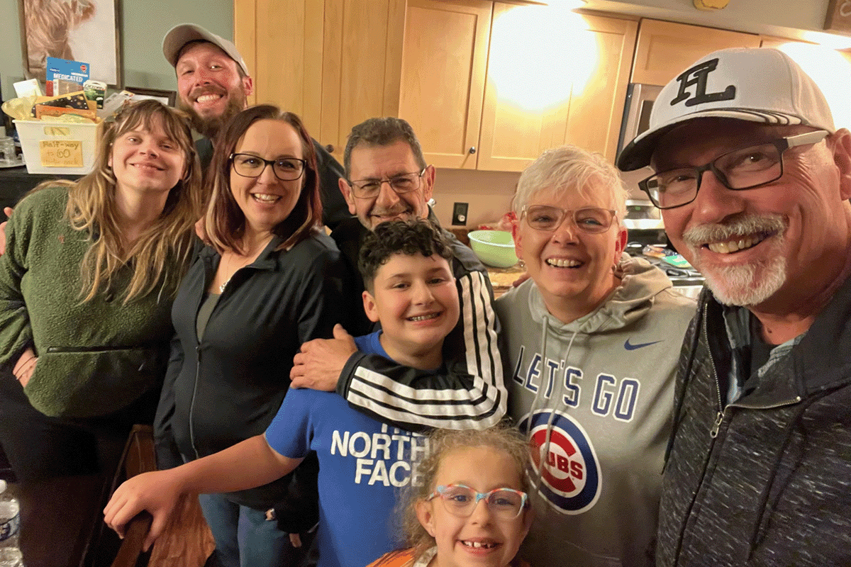 Eight family members spanning three generations pose for a casual photo