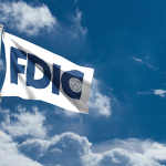 a white flag with an all-blue FDIC logo flying against a blue sky with white clouds